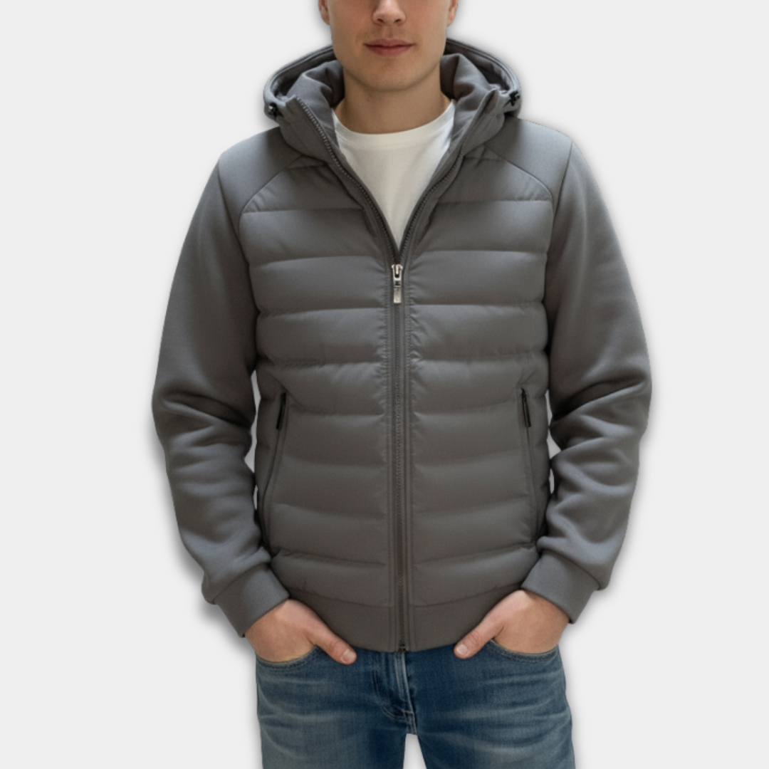 Person wearing a grey puffer jacket on a white background