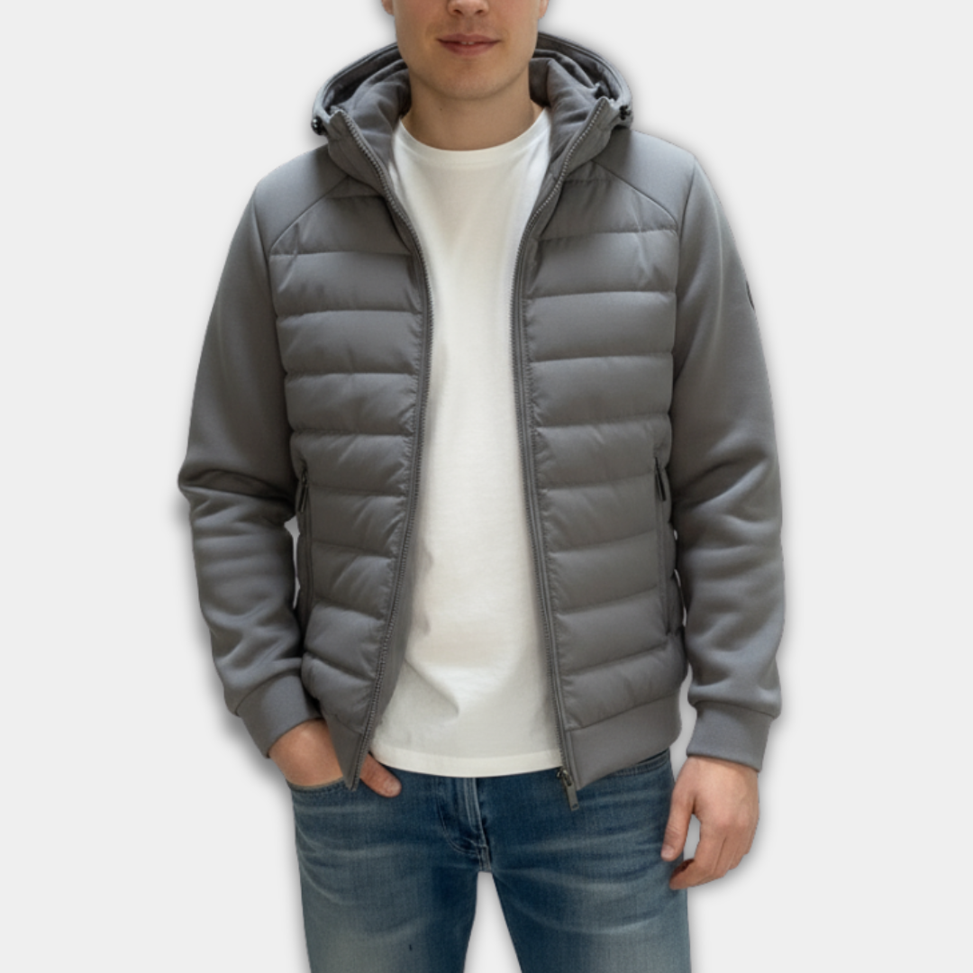 Person wearing a grey puffer jacket on a white background